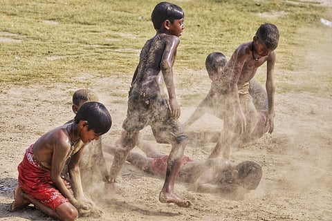 Children play on the bank of River Yamuna on a hot summer day, in New Delhi, Tuesday, April 8, 2025.