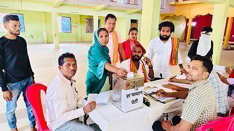 A woman dropping her application in the 'Samadhan Box'