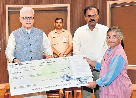 Governor Jishnu Dev Varma hands over demand drafts to four institutions under his discretionary grants at Raj Bhavan in Hyderabad on Wednesday.