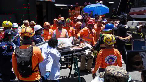 Rescue workers carry a person pulled from the wreckage of the Jet Set nightclub after its roof collapsed during a merengue concert in Santo Domingo, Dominican Republic,
