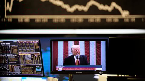 US President Donald Trump appears on a television screen at the stock market in Frankfurt, Germany, Thursday, April 3, 2025.