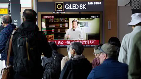People watch a TV screen showing former South Korea's main opposition Democratic Party leader Lee Jae-myung announces his presidential bid via a video message at the Seoul Railway Station in Seoul, South Korea, Thursday, April 10, 2025.