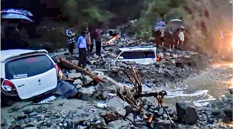 Two vehicles were buried under the debris, and the National Highway was blocked.