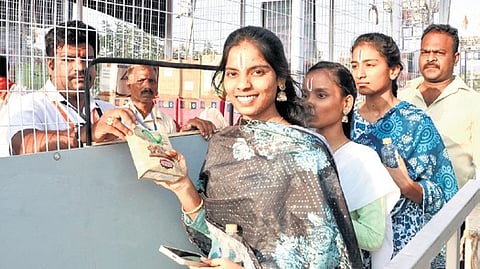 Devotees taking prasadam from temple official at Vontimitta.