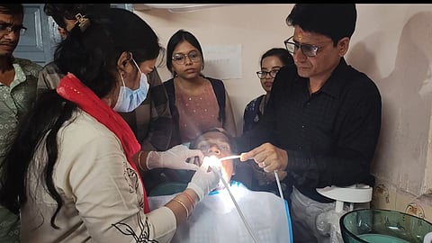 The doctor couple examining a patient at the One Rupee clinic.