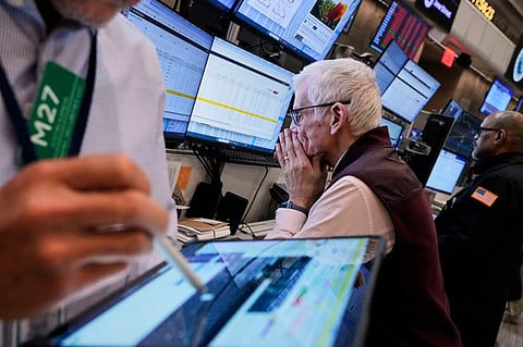 Trader Peter Herits, center, works on the options floor of the New York Stock Exchange, Thursday, April 10, 2025.