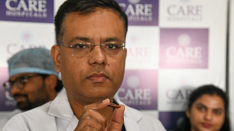 A doctor at CARE Hospitals shows the bullet removed from a Somalian’s brain in Hyderabad on Thursday.
