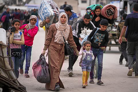 Displaced Palestinians flee from east to west of Gaza City after the Israeli military issued evacuation orders in the area, Friday April 11, 2025.