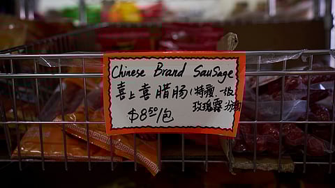 A handwritten price tag for sausage imported from China is seen at a grocery market in the Chinatown neighborhood of Los Angeles, Friday, April 11, 2025.