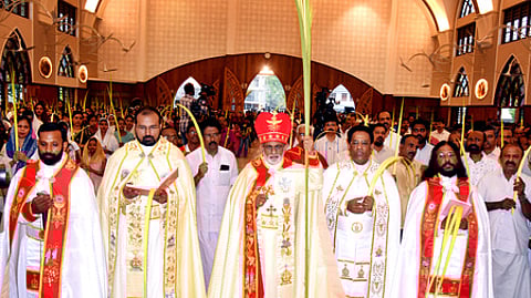 Mar Raphael Thattil, Major Archbishop of the Syro-Malabar Church, leads the Palm Sunday procession at Mary Queen Church, Thoppil.