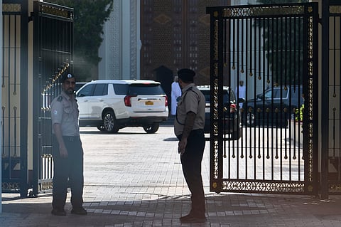 Omani security personnel watch a convoy believed to be carrying US Mideast envoy Steve Witkoff in Muscat, Oman, Saturday, April 12, 2025.