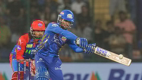 Mumbai Indians' Tilak Varma plays a shot during an Indian Premier League (IPL) 2025 T20 cricket match between Delhi Capitals and Mumbai Indians, at the Arun Jaitley Stadium, in New Delhi, Sunday, April 13, 2025.