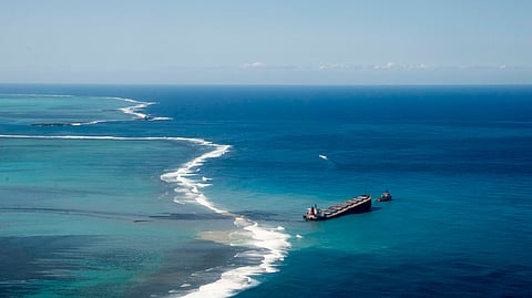 In this photo from Aug. 16, 2020, oil leaking from the MV Wakashio, which ran aground off the southeast coast of Mauritius, is seen spreading in the Indian Ocean.