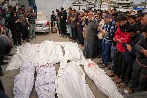 Palestinians pray over the bodie of Abdullah Habbash, along with the bodies of six brothers from the Abu Mahadi family, all members of a Palestinian charity organization linked to Hamas, who were killed earlier in an Israeli army strike on the car they were traveling in, during their funeral in Deir al-Balah, central Gaza Strip, Sunday, April 13, 2025.