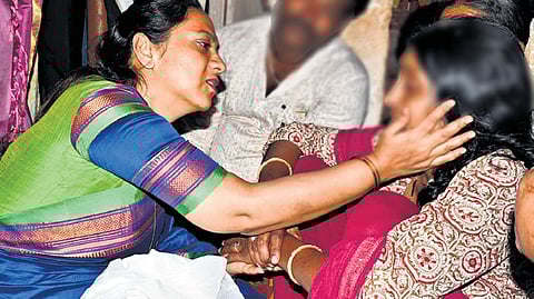 Nagalakshmi Choudhary, president of the Karnataka State Women’s Commission, consoles the mother of the minor girl, in Hubballi on Monday.