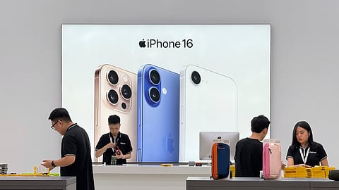 Sales staffs work at an Apple shop in Hanoi, Vietnam Thursday, April 10, 2025.