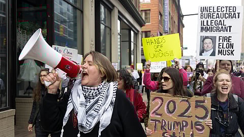 Community organizer Emerson Wolfe leads a march hosted by Indivisible Greater Grand Rapids down Ottawa Avenue during a Hands Off! rally, April 5, 2025, in Grand Rapids, Michigan.