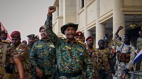 Sudan's military chief Gen. Abdel-Fattah Burhan center, is greeted by troops as he arrives at the Republican Palace, recently recaptured from the Rapid Support Forces paramilitary group, in Khartoum, Sudan, March 26, 2025.