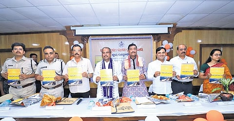 Union Minister Pradhan and other guests at the book launch event in Jharsuguda.