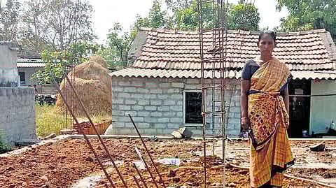 Noonavath Swapna poses for a photo in the under-construction house allotted to her under the Indiramma Housing Scheme at Dharma Tanda in the Palair segment.