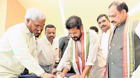 Chief Minister A Revanth Reddy signs the attendance register as he arrives for the Congress Legislature Party meeting in Hyderabad on Tuesday.