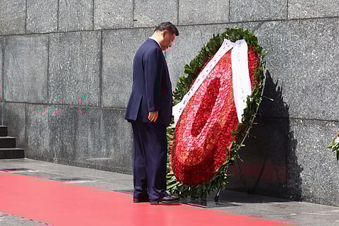 Chinese President Xi Jinping looks at a wreath at the Ho Chi Minh Mausoleum during his visit to Hanoi, Vietnam, Tuesday, April 15, 2025.