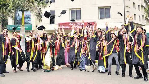 Students throw their caps during the graduation ceremony at GITAM University’s Kautilya School of Public Policy in Hyderabad on Wednesday.