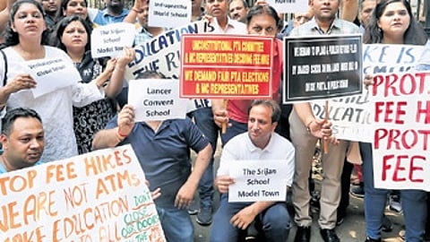 Parents stage protests outside the Directorate of Education office in New Delhi on Wednesday.