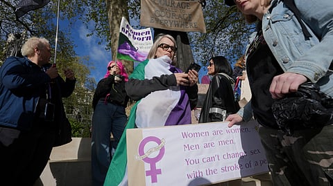 Women's rights activists hold placards outside the Supreme Court to challenge gender recognition laws, in London, Wednesday, April 16, 2025