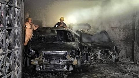 The fire engulfed three to four cars parked in the building's stilt parking.