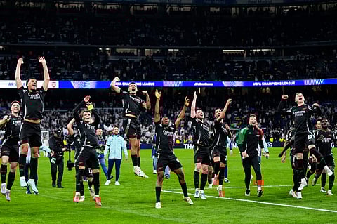 Arsenal players celebrate after defeating Real Madrid 2-1 in the Champions League quarterfinals second leg soccer match at the Santiago Bernabeu stadium in Madrid, Wednesday, April 16, 2025.