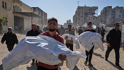 Mourners carry white sacks covering the bodies of members of the Abu Al-Rous family, killed when an Israeli airstrike struck their displacement tent overnight, during their funeral in Khan Younis, southern Gaza Strip, Thursday, April 17, 2025