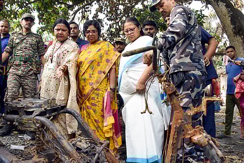 National Commission for Women (NCW) Chairperson Vijaya Rahatkar and other members look at a charred vehicle during a visit to the riot-affected area in Jangipur, in Murshidabad district, West Bengal, Saturday, April 19, 2025.