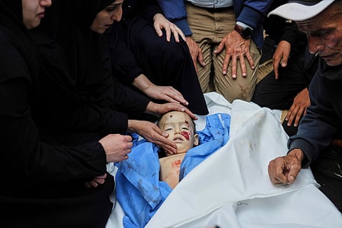 Palestinians mourn over the body of Kinan Edwan, 2 years old, killed in an Israeli army airstrike, during his funeral in Khan Younis, southern Gaza Strip, Saturday, April 19, 2025.
