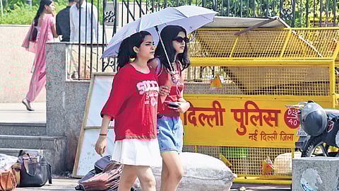 Pedestrians at Connaught Place in New Delhi on Friday.