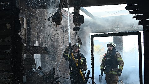 Ukrainian rescuers work to extinguish a fire in a sewing factory following a missile attack in Kharkiv on April 18, 2025, amid the Russian invasion of Ukraine