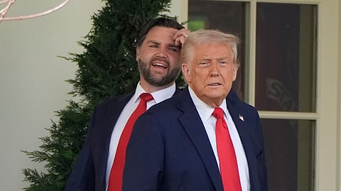 US President Donald Trump and Vice President JD Vance pause near the Oval Office of the White House, April 14, 2025, in Washington.