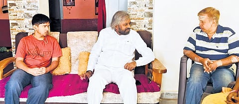 Minister for Forest, Ecology and Environment Eshwar Khandre interacts with Suchivrat Kulkarni and his father in Bidar on Sunday