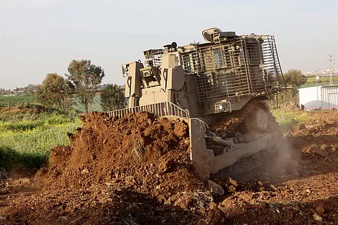 An unmanned D9 bulldozer digs up a field during a demonstration to the press at the Israel Aerospace Industries (IAI) quarters near Tel Aviv on March 26, 2025.