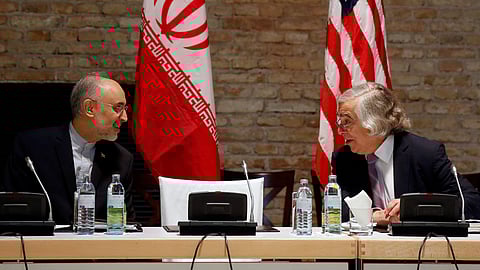 In this photo from July 9, 2015, US Secretary of Energy Ernest Moniz and Head of the Iranian Atomic Energy Organization Ali Akbar Salehi, left, meet at an hotel in Vienna.