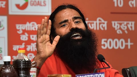 Yoga guru Ramdev addresses a press conference in New Delhi.