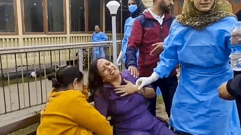 People react after terrorists attacked a group of tourists at Pahalgam, in Anantnag district, Jammu & Kashmir, Tuesday, April 22, 2025.