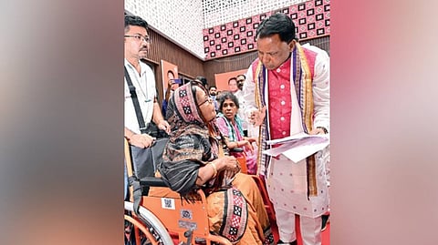 CM Mohan Charan Majhi speaks to an elderly woman during the Jana Sunani