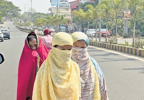 Covered with scarves, girls commute on a road in Jharsuguda on Tuesday