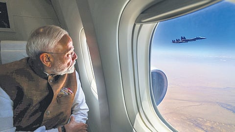 Prime Minister Narendra Modi looks at the fighter jets of Royal Saudi Air Force escorting his aircraft as it arrives in Jeddah on Tuesday.