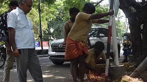 CCMC officials engaged in removing Political flag posts near LIC office on Tiruchy road in Coimbatore on Tuesday. (for Aravind Rajs story).