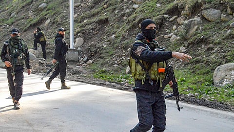 Security personnel stand guard on a road near the site of the terror attack at Pahalgam, in Anantnag district, Jammu and Kashmir, Wednesday, April 23, 2025.