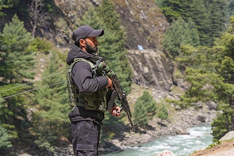 A security personnel keeps vigil, a day after a terrorist attack in Pahalgam, J & K, Wednesday morning, April 23, 2025.