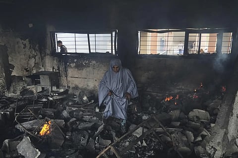 Palestinians inspect the damage after an Israeli army airstrike on Yaffa school, in Gaza City, Wednesday, April 23, 2025.