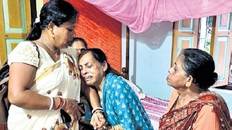 Prasant’s grieving mother Padmabati being consoled by relatives